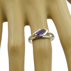 Hua purple solitaire ring for women with oval gemstone set in silver band on display hand