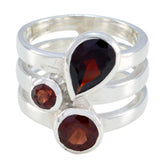 Paula statement red gemstone ring with three deep red stones set in a silver triple band design