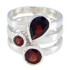 Paula statement red gemstone ring with three deep red stones set in a silver triple band design