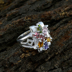 Leah silver multicolor gemstone ring floral cluster with green pink orange and purple stones on bark