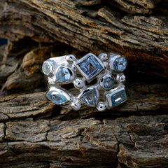 Meera silver statement ring with mixed cut blue gemstones on rustic wood background trendy blue gemstone ring