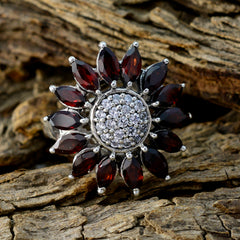 Ella abstract red gemstone ring floral design marquise deep red stones around pave crystal center in silver setting on wood