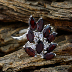 Aurora trendy red gemstone ring with marquise cut stones and silver band on rustic wood