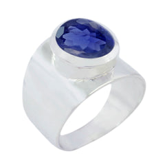 Camilla blue solitaire statement ring featuring a large faceted blue gemstone set in a wide silver band