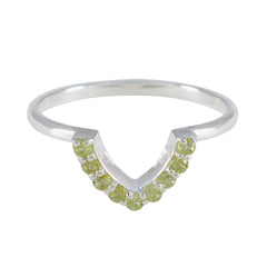 Naomi green gemstone crown ring with small round green stones set in silver band