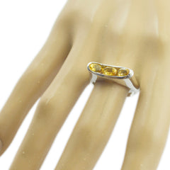 Eliza modern yellow gemstone ring with three oval yellow stones on silver band worn on hand