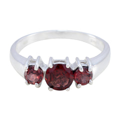 Hua silver red gemstone trilogy ring with three round red gemstones on a polished band