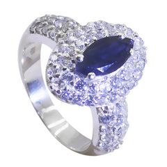 Julieta trendy blue halo ring featuring a marquise blue gemstone surrounded by sparkling white stones