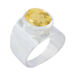 Camila yellow solitaire statement ring with a wide silver band and oval yellow gemstone