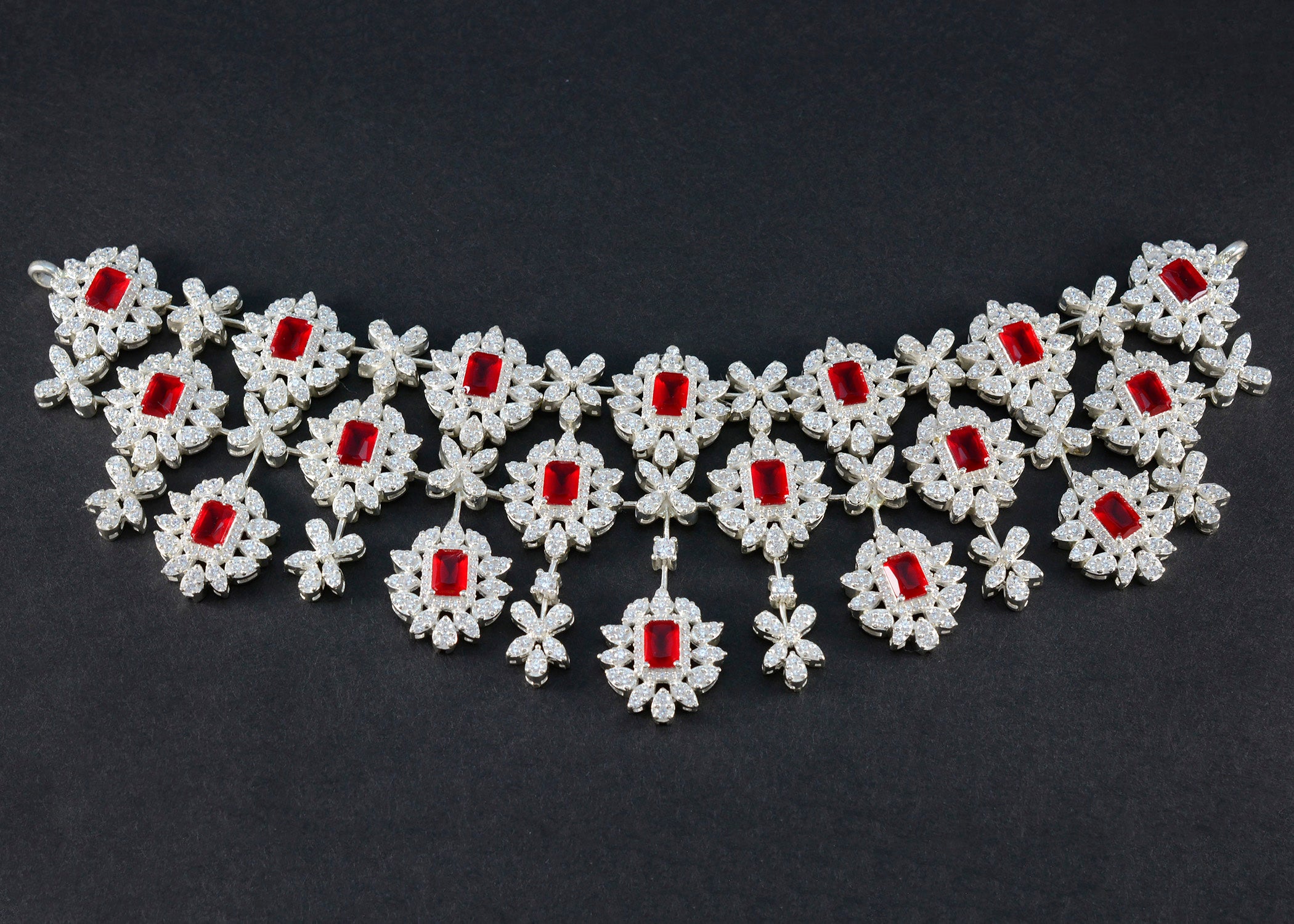 Bridal red stone necklace designed with intricate floral patterns and sparkling accents