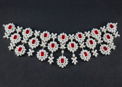 Bridal red stone necklace designed with intricate floral patterns and sparkling accents