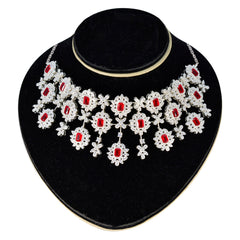 Bridal red stone necklace with intricate silver floral design for elegant wedding attire