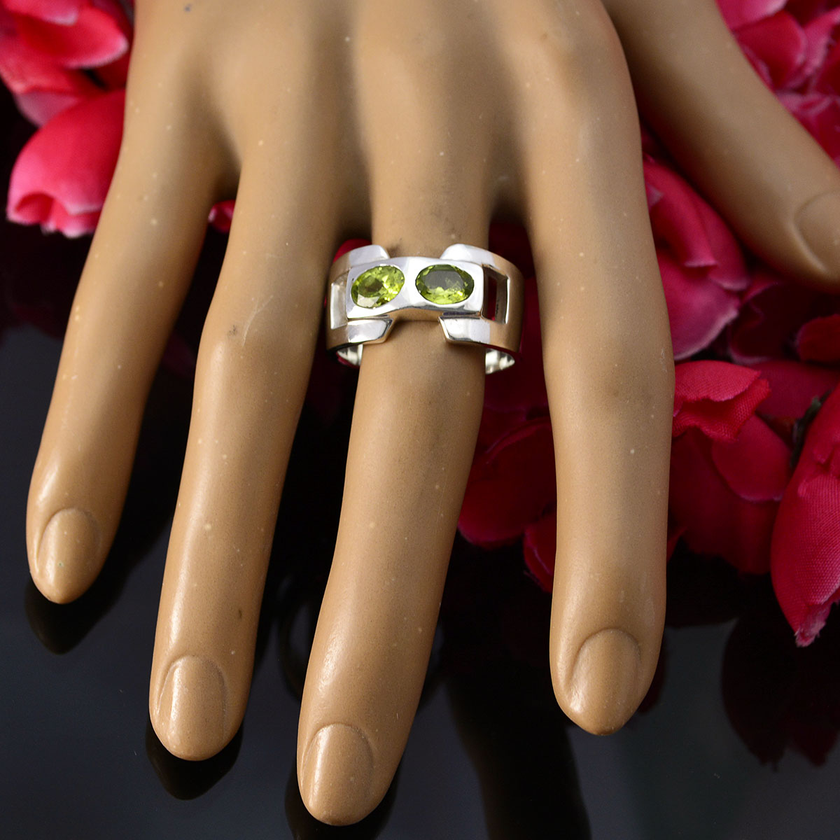 Siti green toi et moi ring with two oval green gemstones set in silver band on mannequin hand