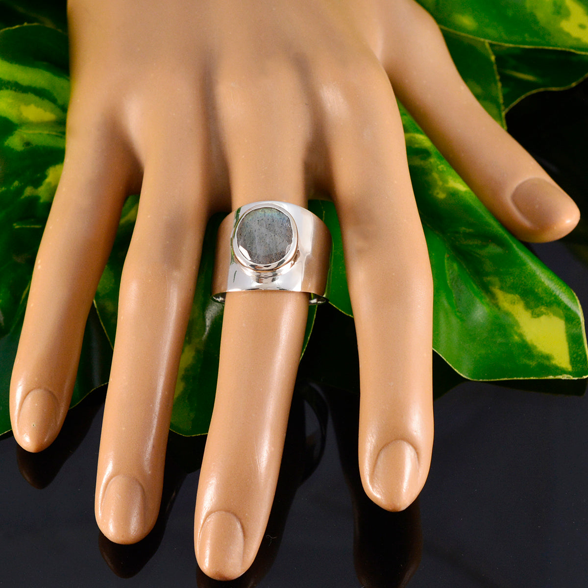 Araya grey solitaire ring for women with a wide silver band displayed on a mannequin hand