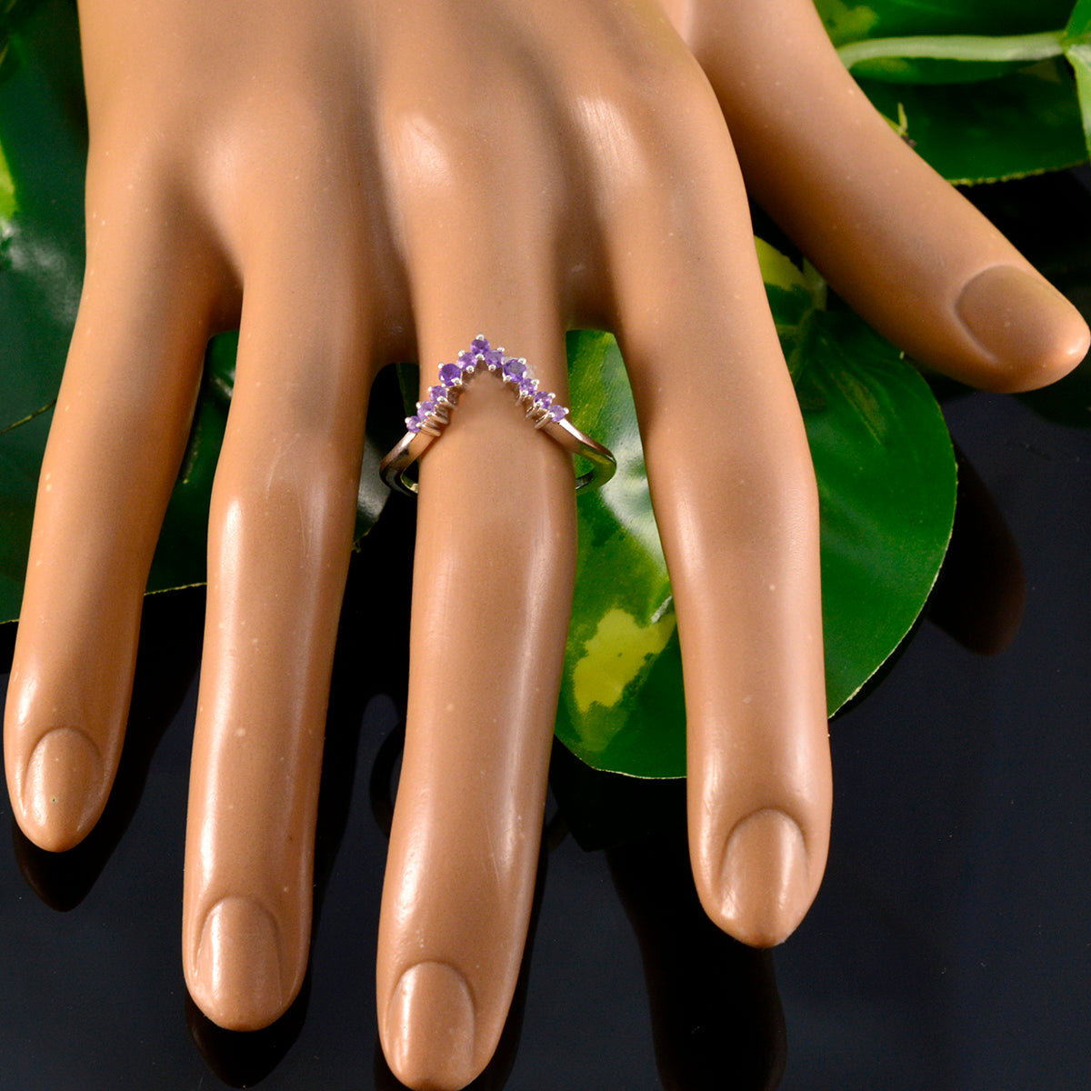 Jia purple gemstone crown ring V shaped silver band with small purple stones shown on mannequin hand