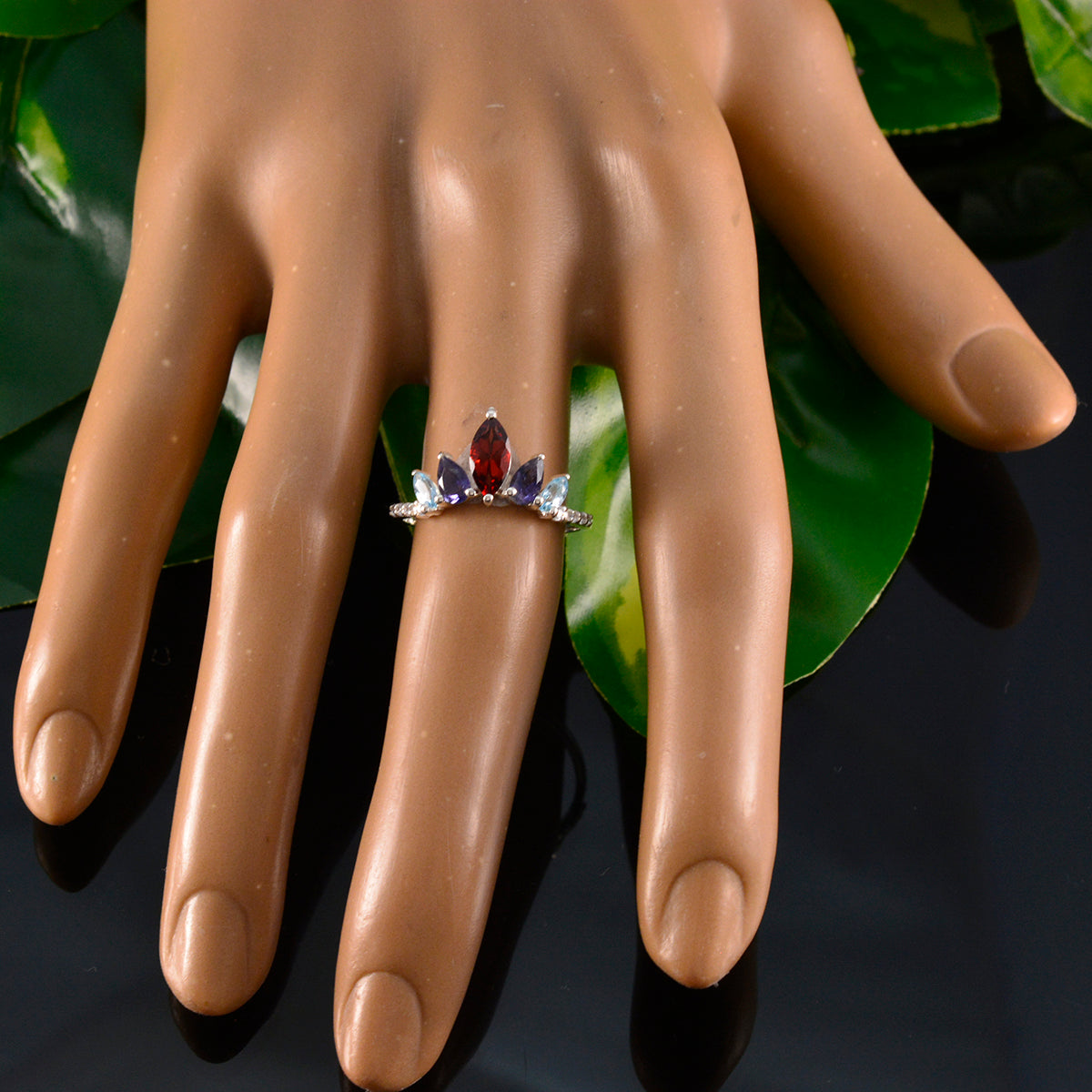 Seo-yeon multicolor gemstone crown ring with red and blue stones on a display hand