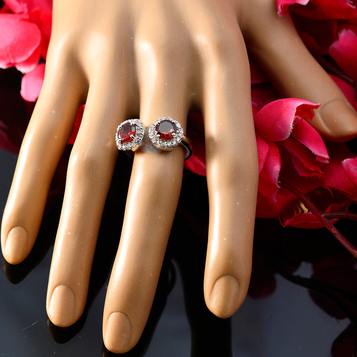 Elegant red toi et moi ring featuring two round gems with sparkling accents on a stylish band