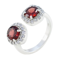 Elegant red toi et moi ring with two oval red gemstones surrounded by sparkling stones