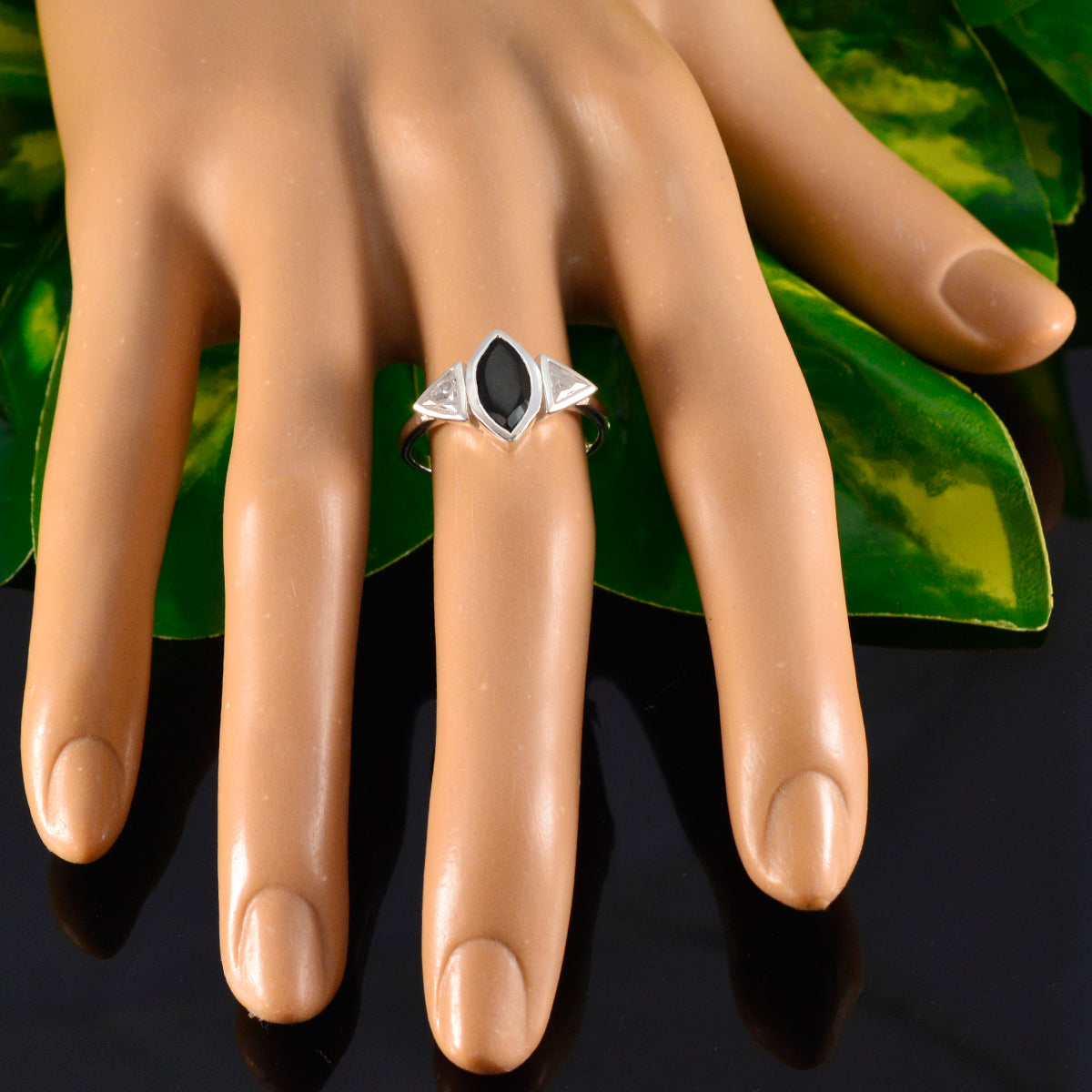Lucia black gemstone trilogy ring with marquise black center and two triangular side stones on mannequin hand