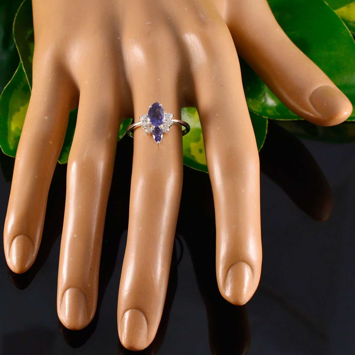 Eun-ji blue gemstone toi et moi ring featuring two purple stones on silver band displayed on hand mannequin