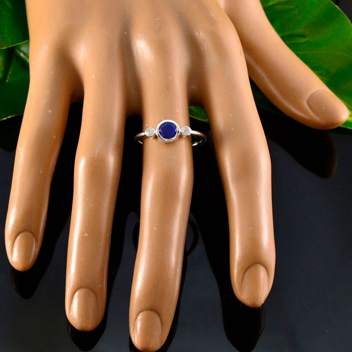 Seo yeon sterling silver ring with round blue center and two side diamonds blue gemstone trilogy ring on mannequin hand