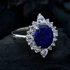 Maria blue halo gemstone ring with oval deep blue center surrounded by pear and round clear stones on silver band