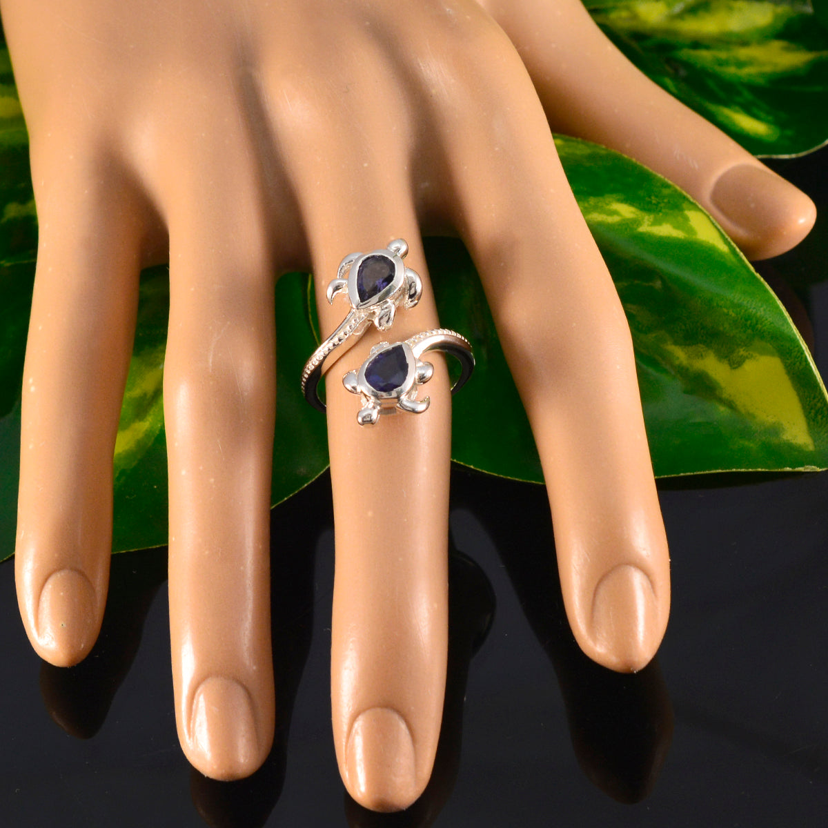 Giulia blue toi et moi ring on mannequin hand silver band with two blue teardrop stones and milgrain detail