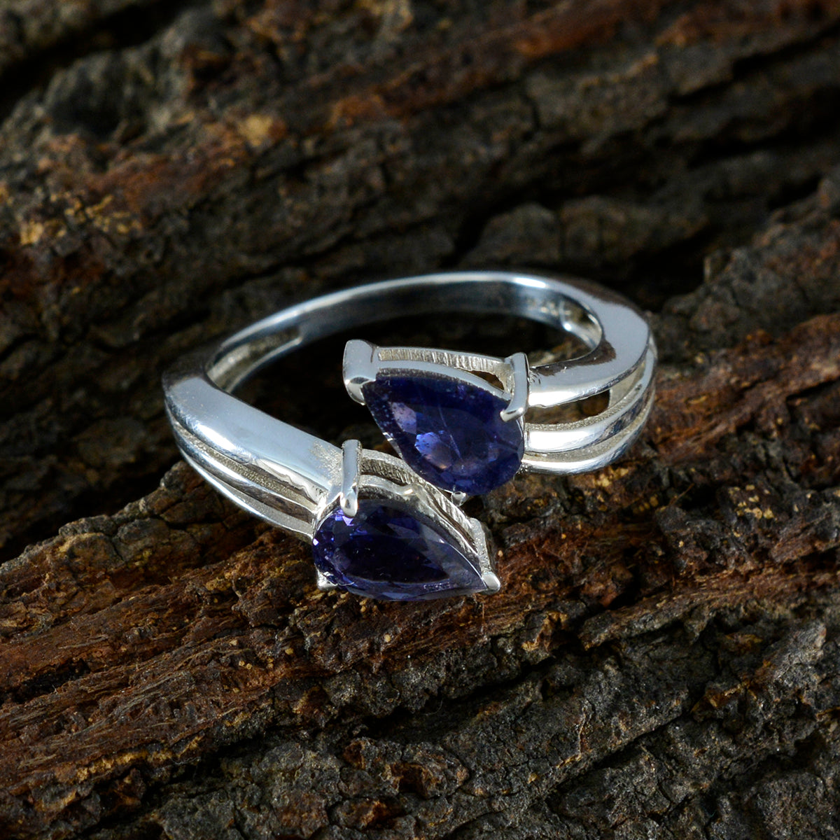 Natcha blue toi et moi ring sterling silver band with two pear shaped sapphire like blue stones on wood