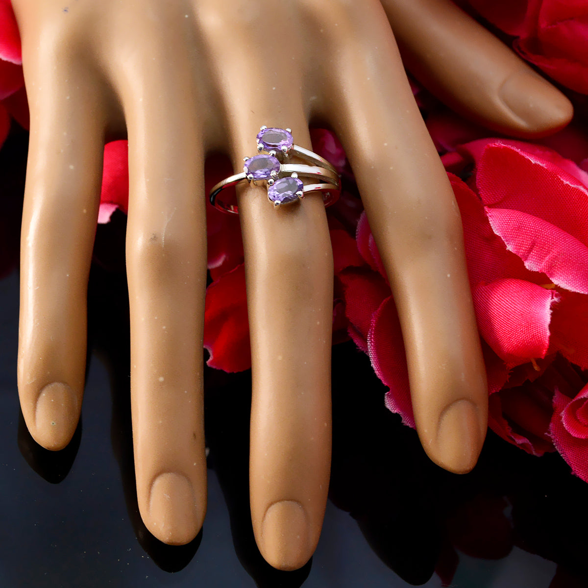 Laura boho purple gemstone ring with three oval stones on a silver band displayed on hand mannequin