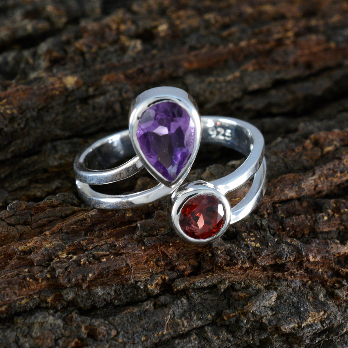 Dayana boho toi et moi ring with two gemstones in silver setting on rustic wood background