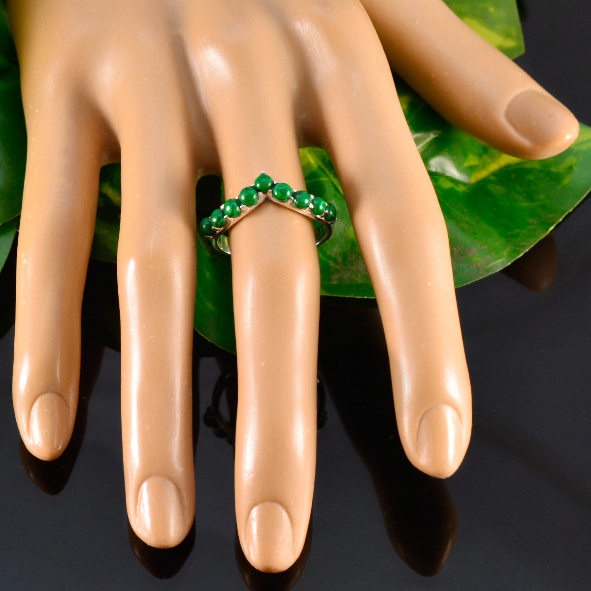 Hina green gemstone ring for women displayed on a mannequin hand chevron green stone band for stacking
