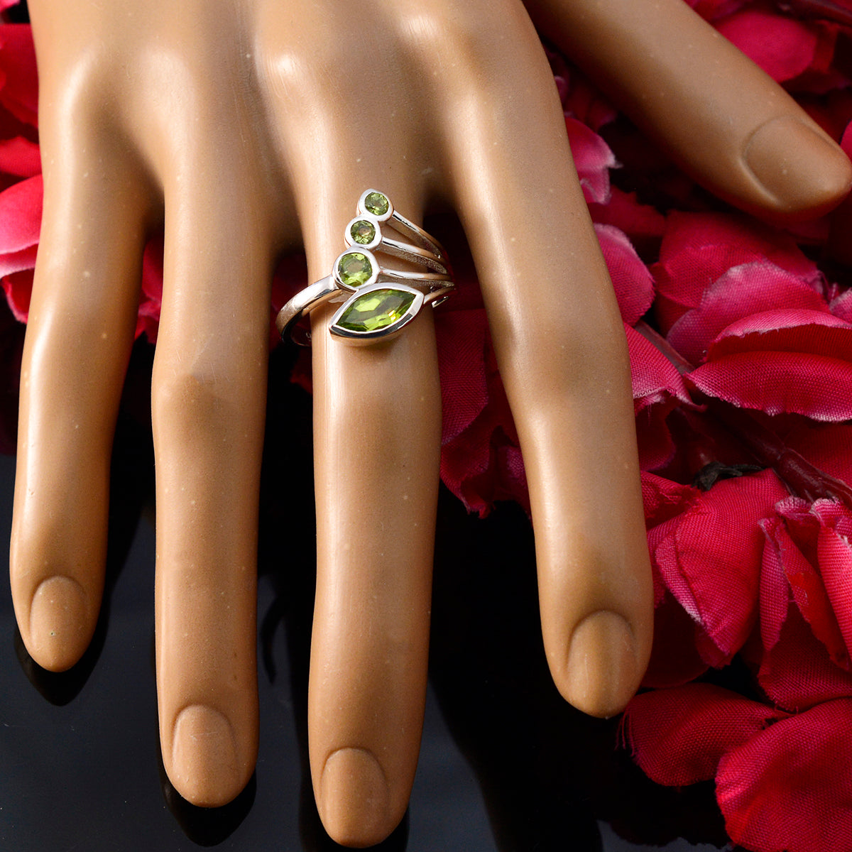 Camila silver ring with marquise and three round peridot stones on mannequin hand green gemstone ring for women