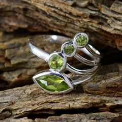 Camila sterling silver ring with marquise and round peridot stones green gemstone ring for women on rustic wood