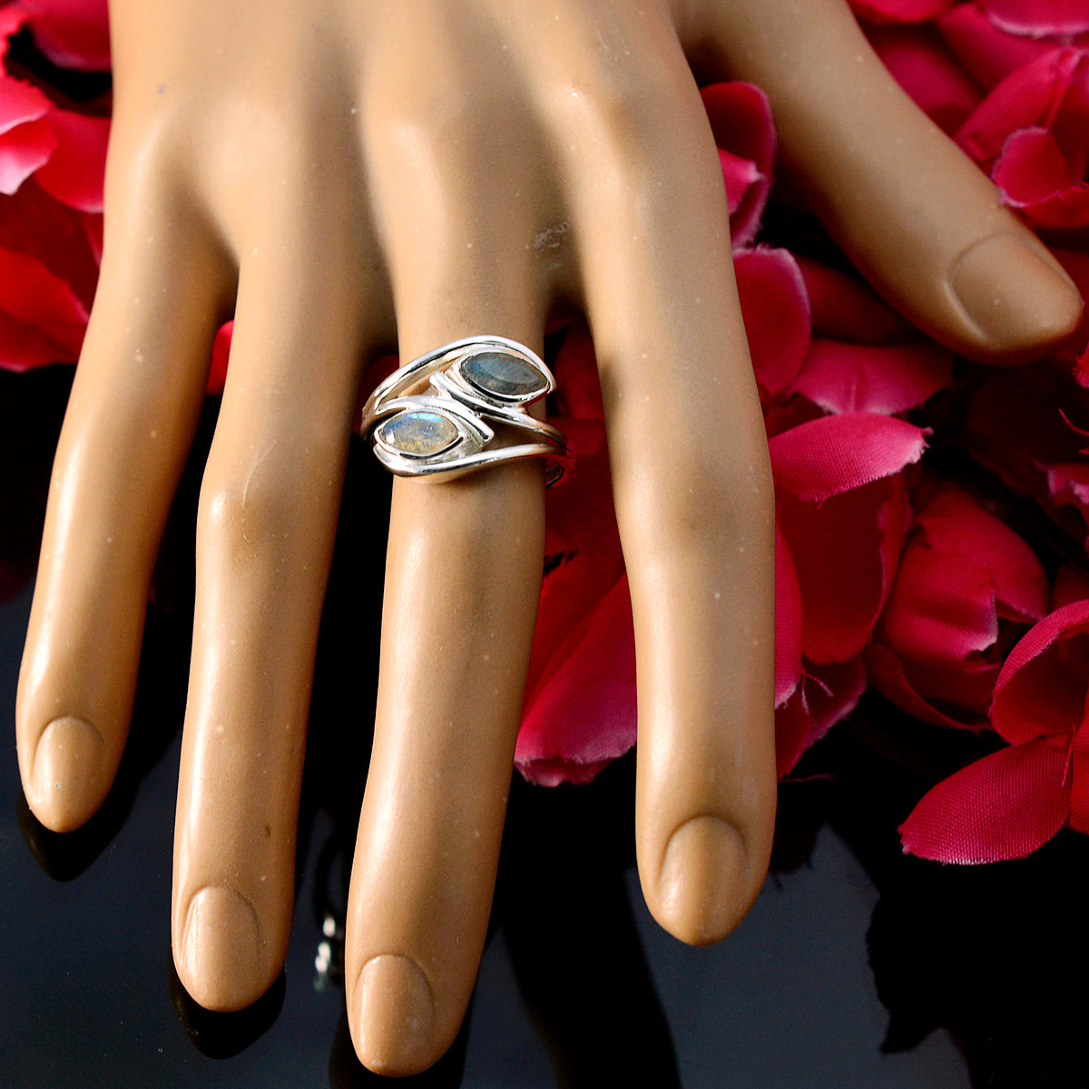 Isabel abstract grey toi et moi ring. on mannequin hand with two marquise stones and rose petals