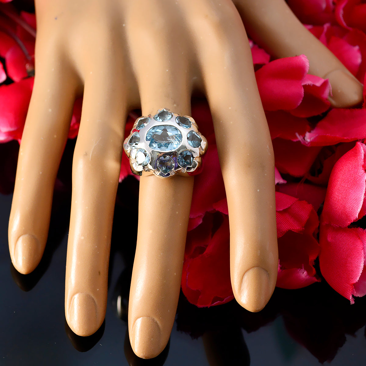 Maya artisan blue gemstone ring with multiple blue stones set in a silver band on a display hand