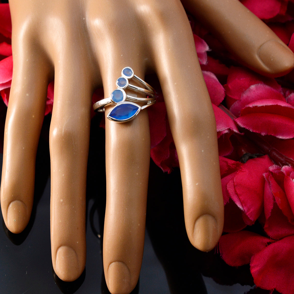 Bruna blue gemstone ring for women with multiple blue stones set on silver band displayed on hand