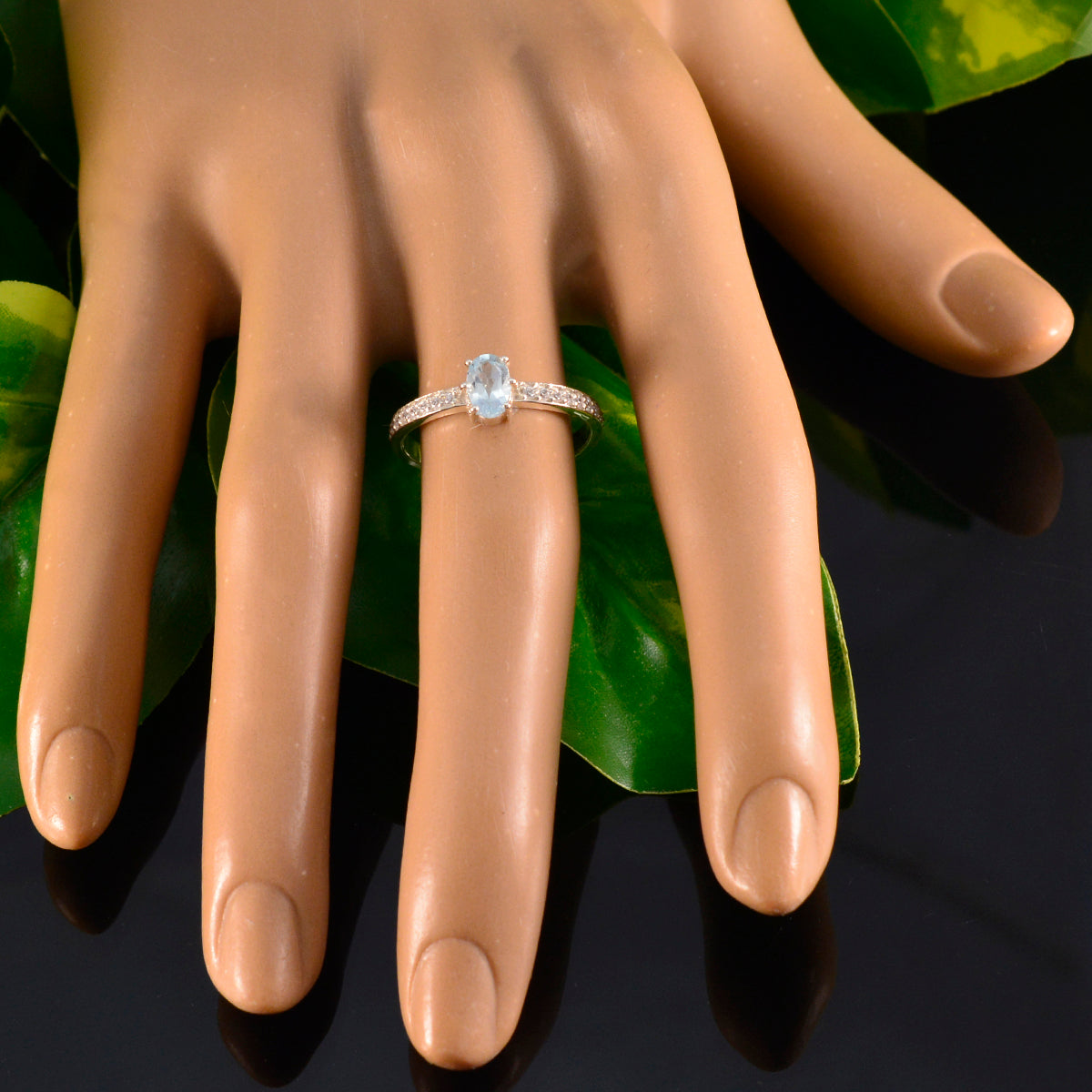 Eun-ji blue halo ring for women with oval blue gemstone and sparkling band on hand model