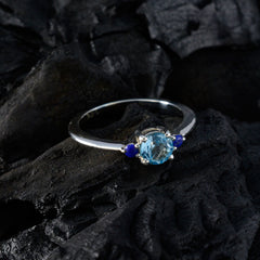 Lili silver ring with light blue center stone and two small blue accents on black rock colorful stackable rings for women