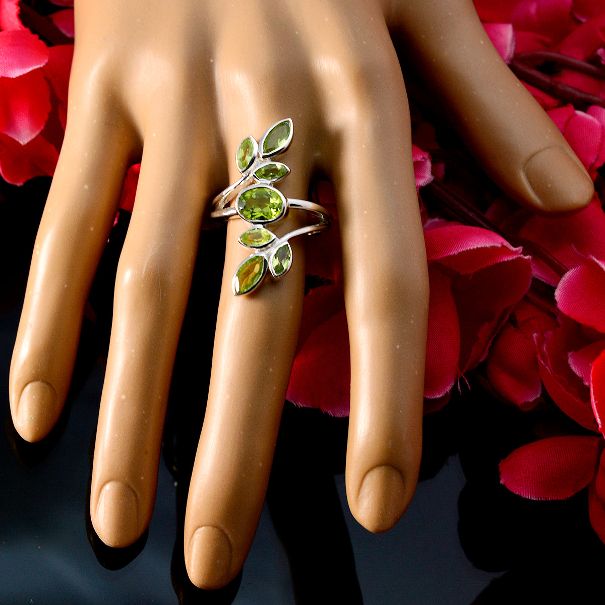 Araya green gemstone leafy ring with multiple green stones displayed on a hand mannequin