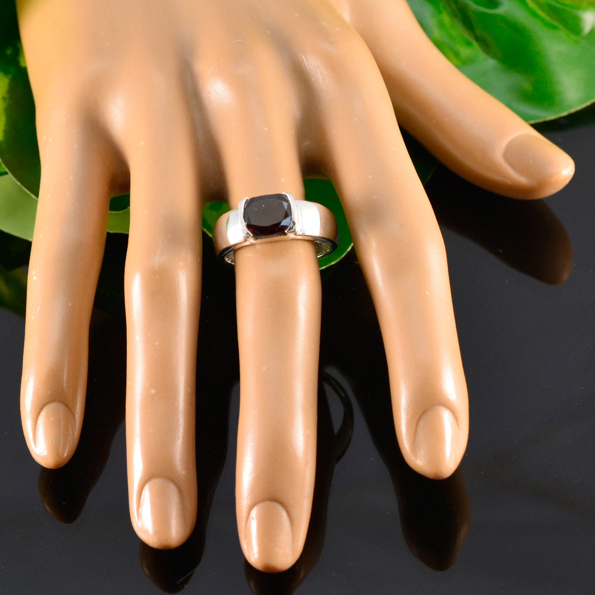Saanvi luxurious red solitaire ring in silver with cushion red gemstone on mannequin hand