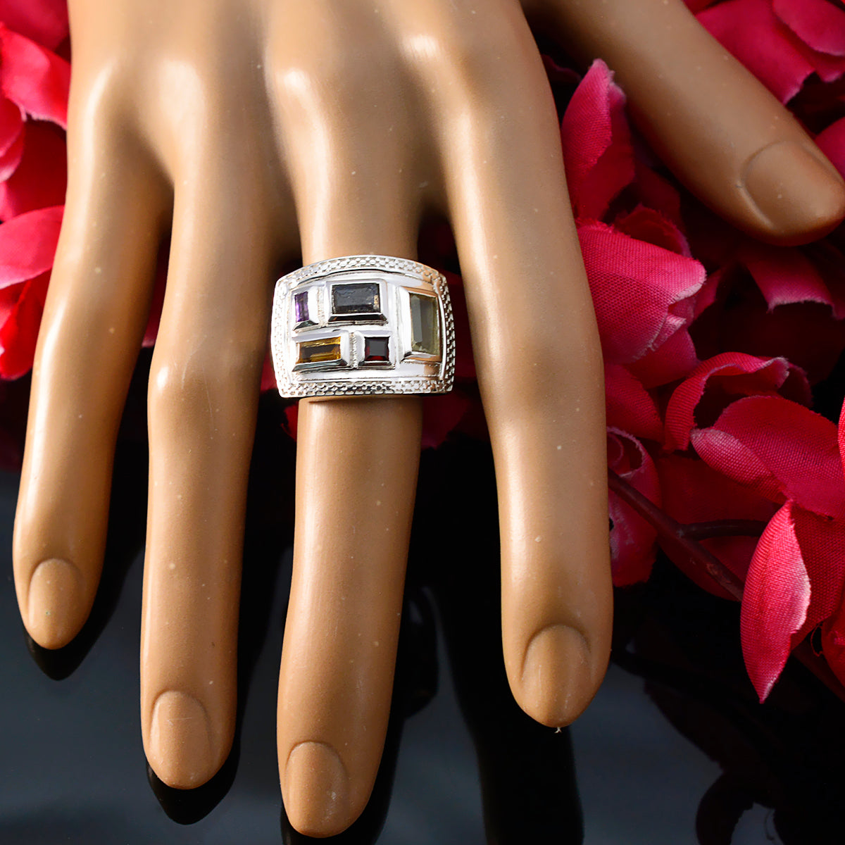 Ines multicolor gemstone cocktail ring with geometric stones on display hand over black background