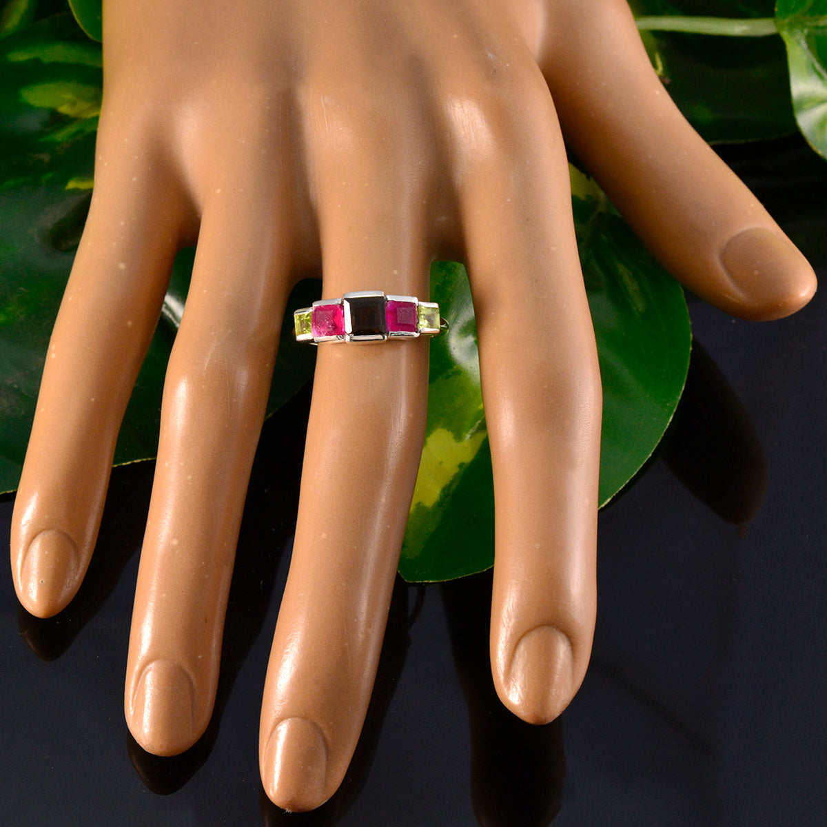 Aurora multicolor gemstone penta ring on mannequin hand silver band with pink black and green stones