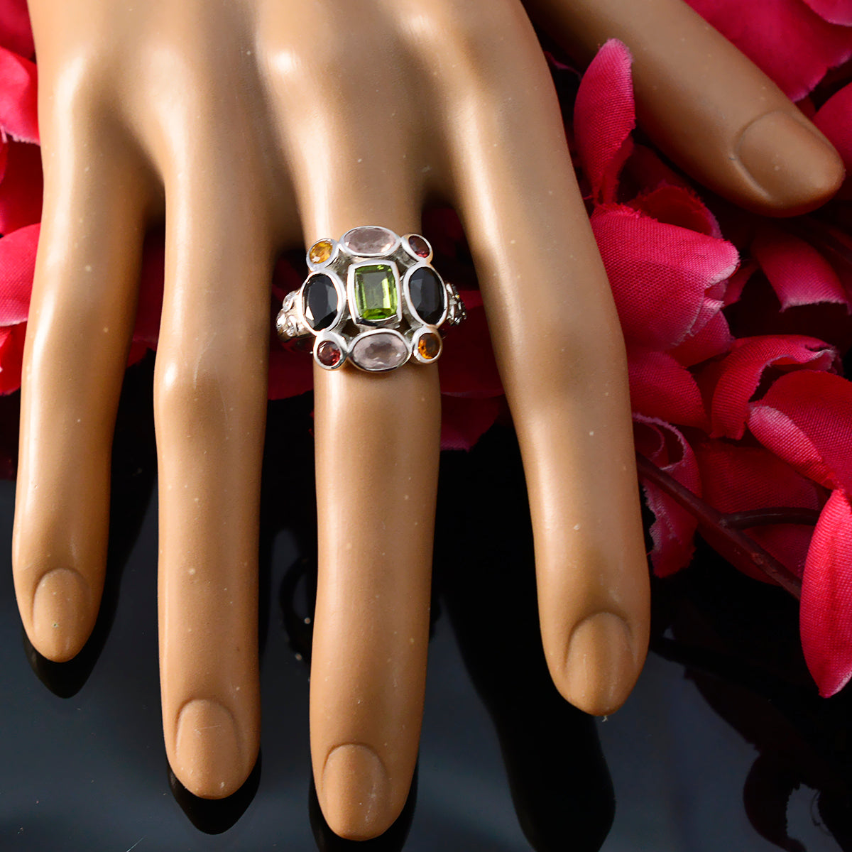 Laura multicolor navratna cocktail ring with various colorful gemstones on a hand model