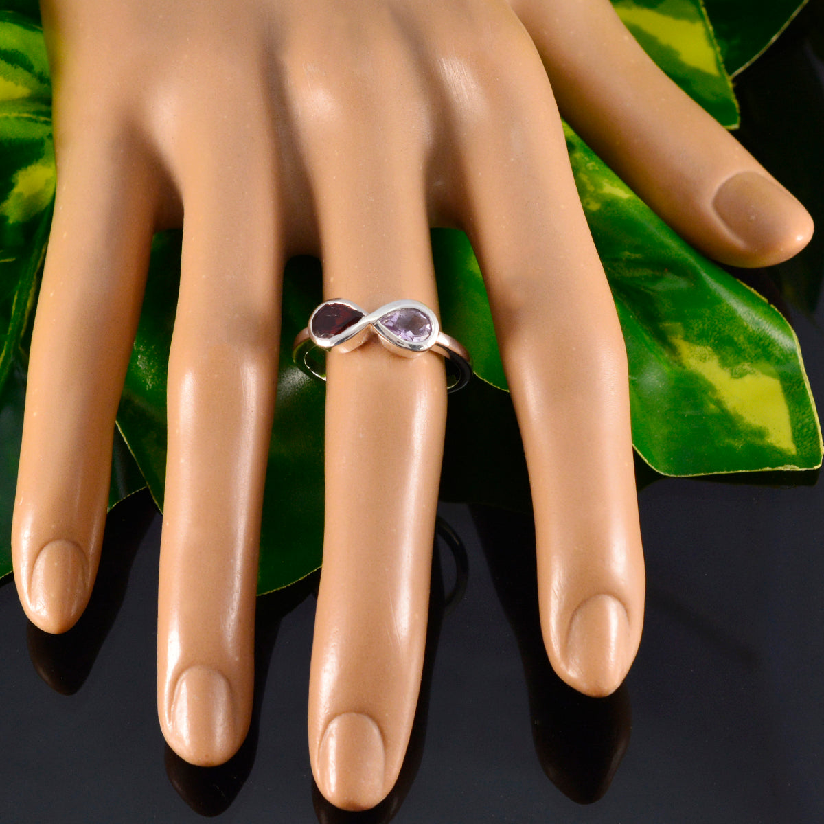 Hua multicolor Toi et Moi ring on mannequin hand silver infinity band with purple and pink gemstones