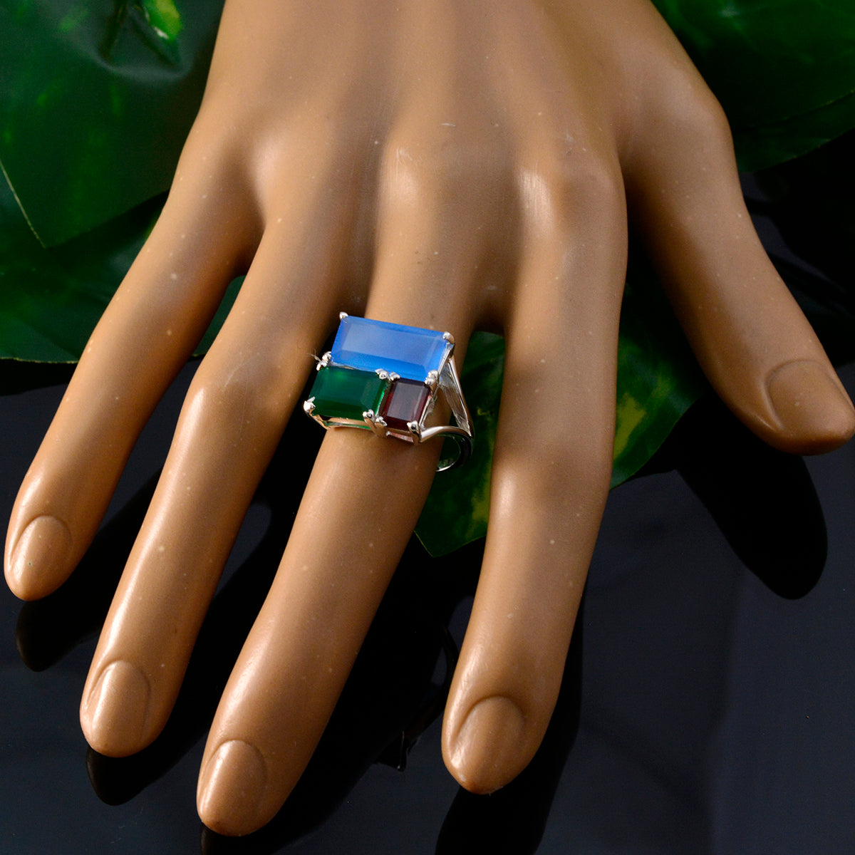 Charlotte multicolor trilogy cocktail ring on a mannequin hand with rectangular blue green and red stones in silver setting