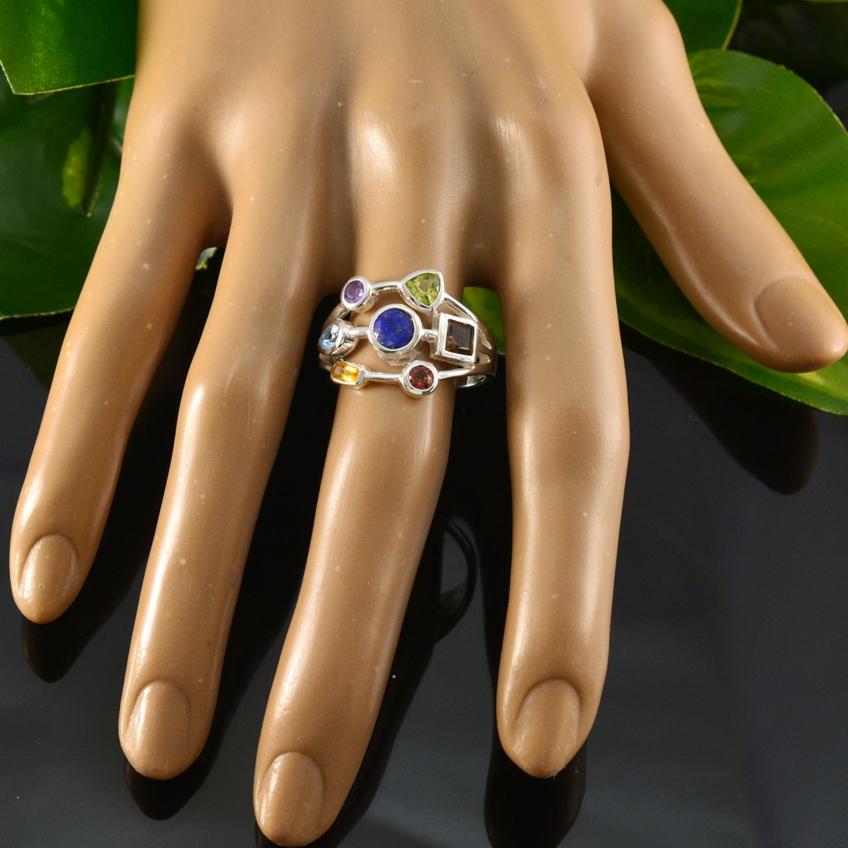 Camila modern multicolor gemstone ring with various shaped stones on a display hand