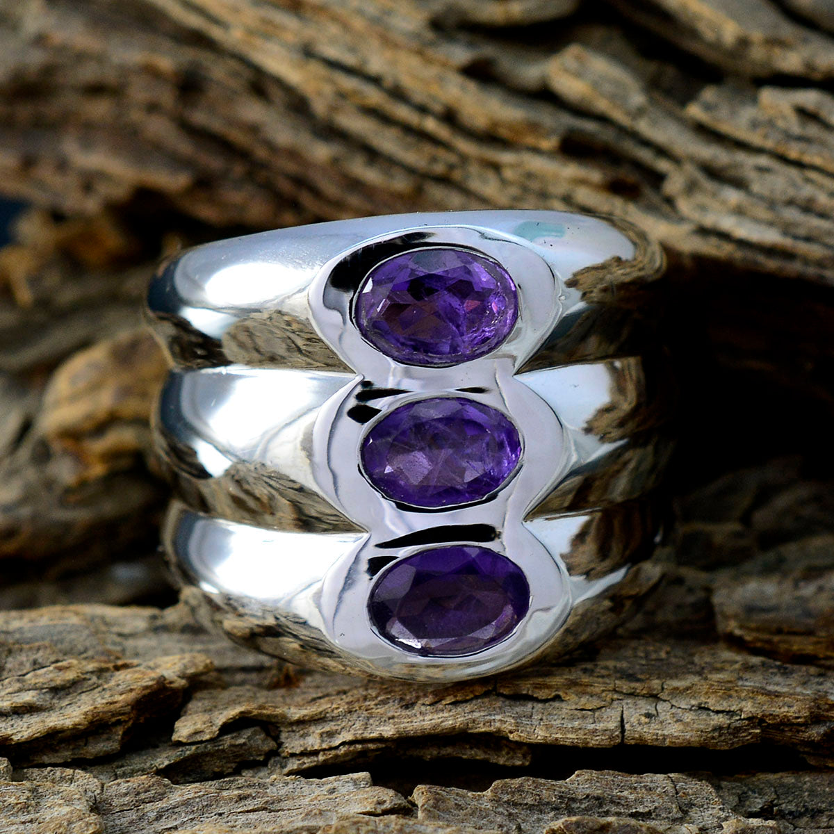 Emily modern purple trilogy ring with three oval purple gemstones set in polished silver band