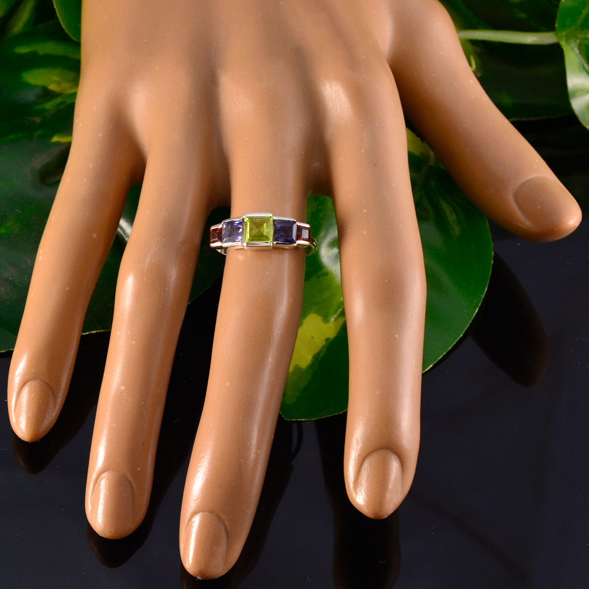 Emi multicolor gemstone ring for women with green and purple stones on display hand