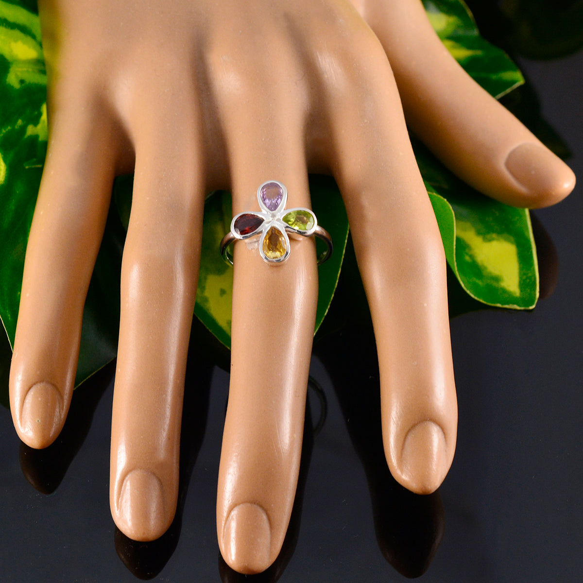 Ha-eun multicolor gemstone ring with four different colored stones on a silver band displayed on a hand