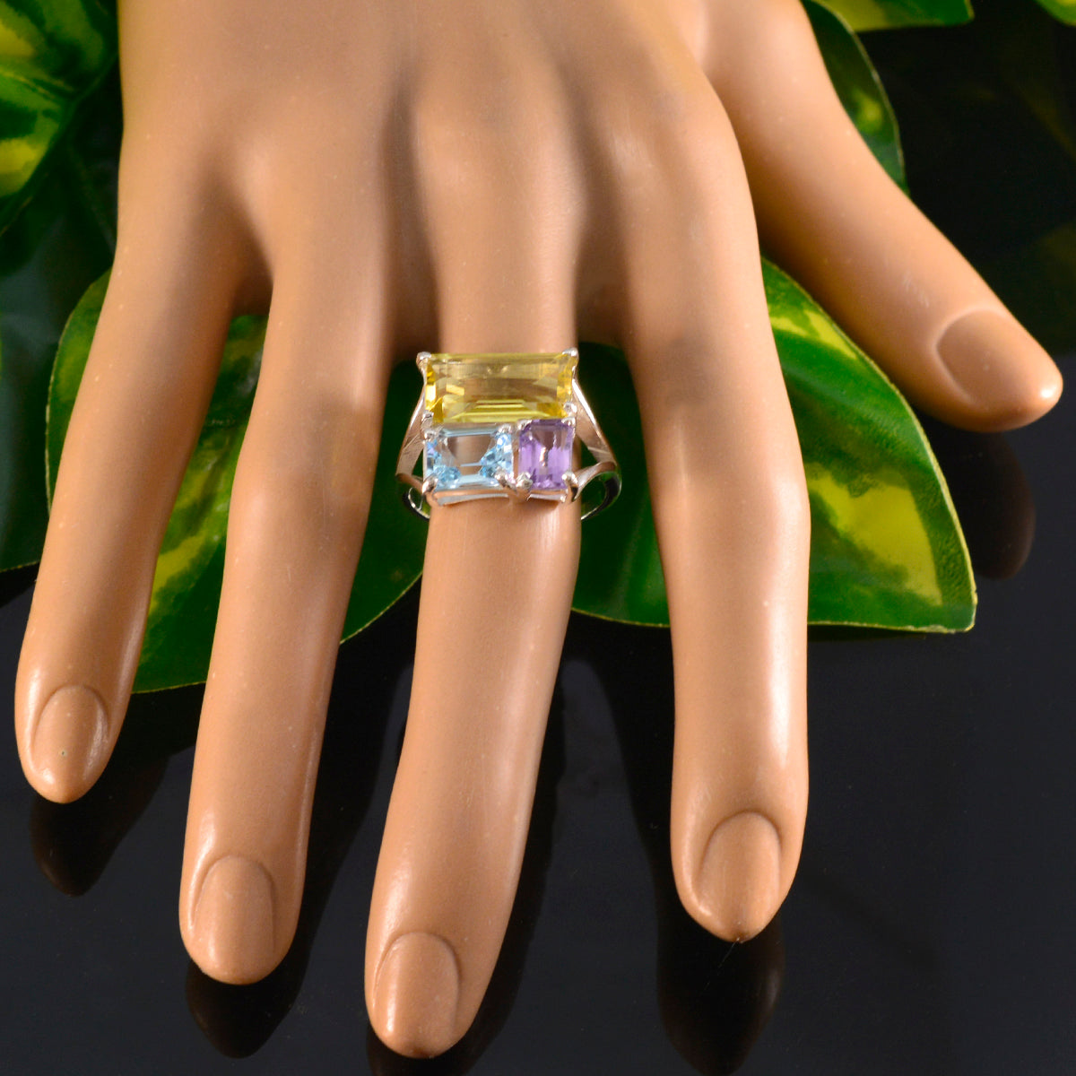 Rosa multicolor trilogy ring with yellow, blue, and purple gemstones on a mannequin hand